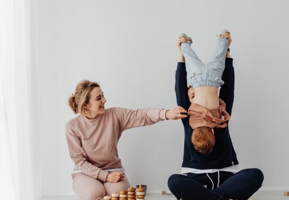 Mother and child enjoying playful time indoors with educational toys.